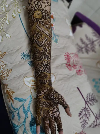 This design features a mix of bold geometric shapes and delicate floral patterns, creating a striking contrast on the arm.