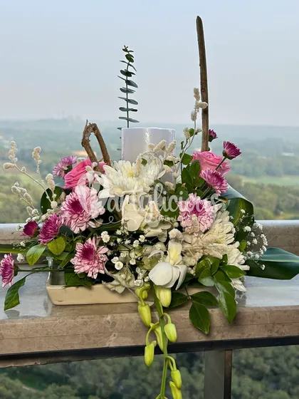 Turn any corner into a celebration. This beautiful floral arrangement with pink and white chrysanthemums is perfect for adding a touch of elegance to a side table or entryway.