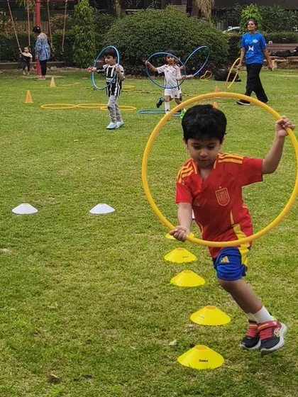 A young champion dashes through a cone drill, developing balance and spatial awareness. Our First Kicks program makes learning foundational skills feel like a game.