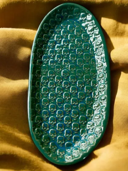 An example of my more playful and edgy work, this oval tray features a repeating skull pattern under a rich green glaze. It’s a statement piece of clay art, proving that handmade pottery can be both fun and a little bit punk.
