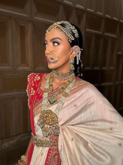 A side profile of the South Indian bridal look, showcasing the elaborate hairstyle and the way the makeup enhances the bride's features from every angle.