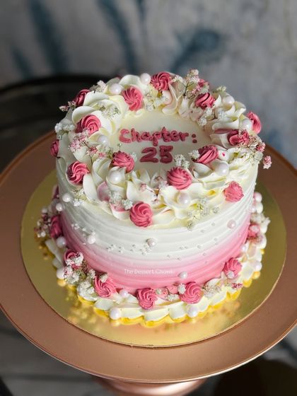 A pretty pink ombre cake to celebrate "Chapter 25." The delicate piping and baby's breath flowers give it a soft, dreamy look.