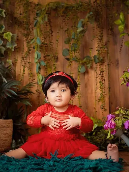 Her expressions are just priceless. This setup allows for a variety of poses, from sitting to crawling, all within a beautiful garden scene.