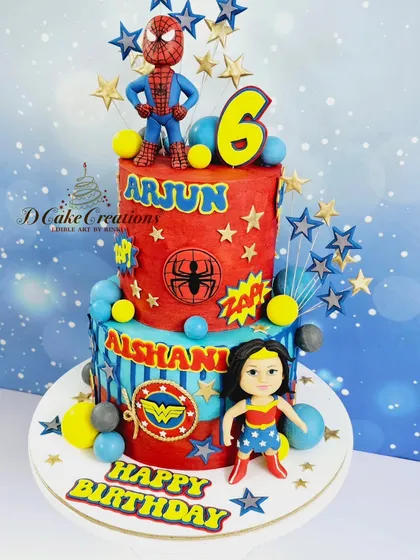 A superhero showdown on a two-tier cake for Arjun and Aishani's 6th birthday. Spiderman stands guard on top while Wonder Woman is ready for action below.