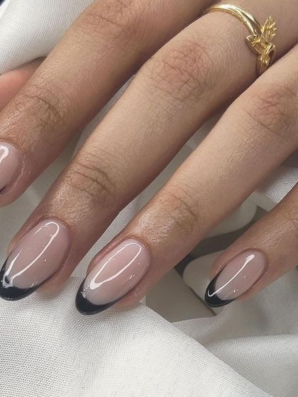 A sleek black French tip on a long almond nail. This is a sophisticated and modern choice for anyone who loves a darker, edgier style.