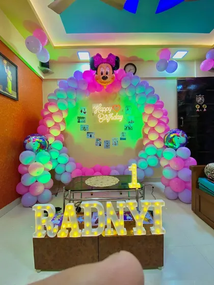 The same Minnie Mouse setup with green lighting, showing the versatility of the decor with simple light changes.