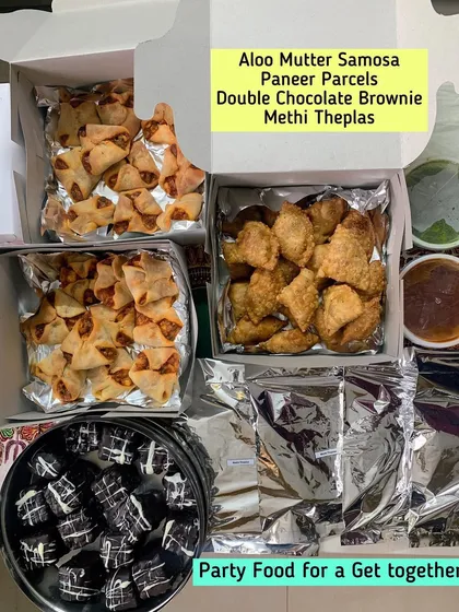 Party food for a get-together, including Aloo Mutter Samosas, Paneer Parcels, and Double Chocolate Brownies.