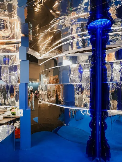 This view captures the energy of the 'Mercury' booth, with its complex reflections and layers of light. Every angle offers a new perspective, a new visual story, ensuring the experience is unique for every visitor.