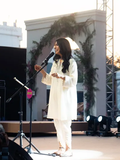 Nayab Midha in her element on stage. The makeup is designed to catch the light beautifully, giving her a radiant glow as she performs.