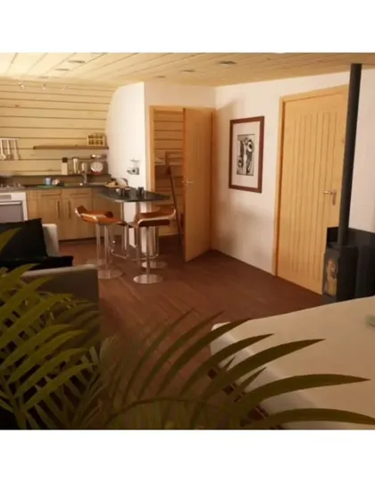 This unique "log-like" cabin design shows our creative potential. The exterior is a loop of shingles, while the interior is a cozy, fully-equipped living space with a kitchen, bed, and seating area.