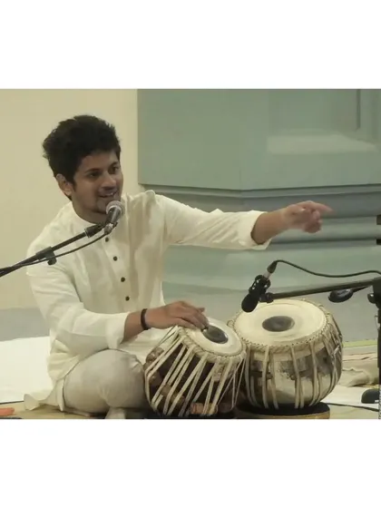 Interacting with the audience during a solo recital. I enjoy breaking down the complexities of the taal and compositions to make the experience more engaging for everyone.