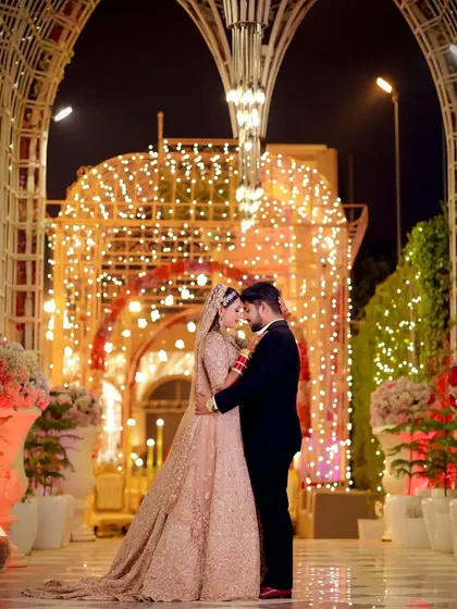 Your reception is a grand celebration, and your photographs should reflect that. I specialize in capturing the scale and beauty of your venue, like this stunning shot of Tanu and Kunal, creating an image that feels both epic and personal.