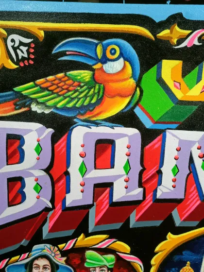 A detail shot of the toucan bird from the "Villa Bam Bam" piece.
