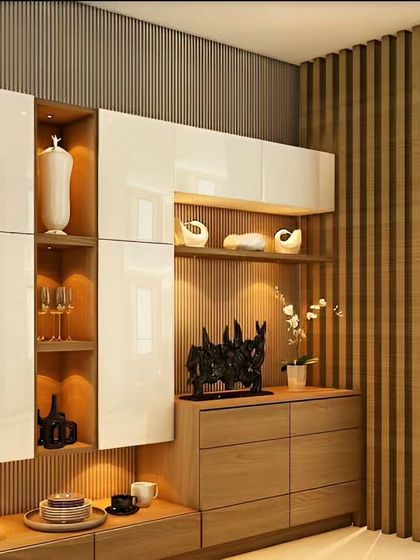 A detailed view of the custom crockery unit with high-gloss white doors and wood accents. The integrated lighting and vertical wood slats add texture and sophistication.