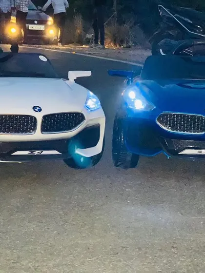 Our kids' ride-on BMW Z4 cars, available in white and blue. These electric cars are perfect for making a grand entrance or for supervised driving fun at parties.