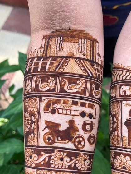 Another angle showing the custom bus and bike motifs. It's these unique, personal touches that make storytelling mehendi so special and different from standard designs.