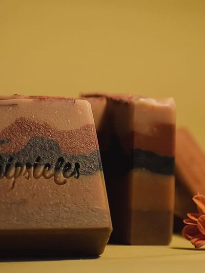 A beautifully lit shot of our Sandalwood Cold Process Soap. The layers of natural clays are clearly visible, showcasing the artistry that goes into each bar, perfect for the sacred first bath of Diwali.