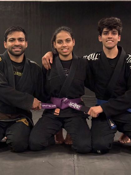 A proud moment as coaches award a new belt. This represents countless hours of dedication from both the student and her mentors.