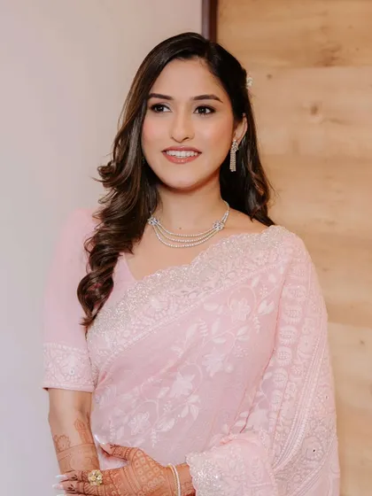 A beautiful profile shot showing the soft contour and glow on her skin. This look is perfect for daytime engagement ceremonies.