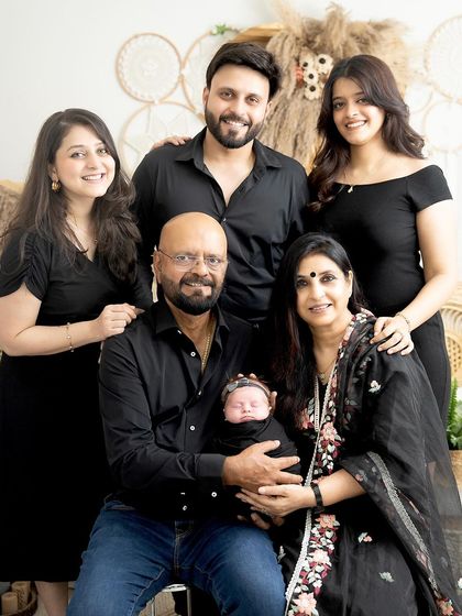 A portrait of generations. This heartwarming photo includes the newborn with her parents and grandparents, a beautiful keepsake of family love.
