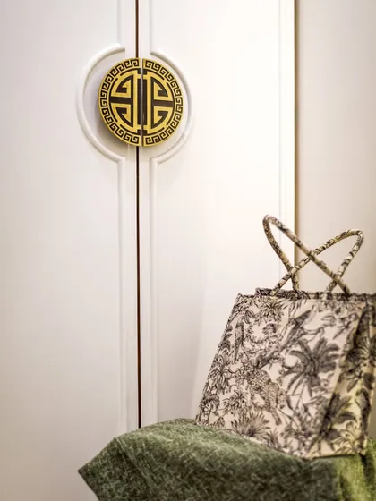 A close-up of the custom Chinese-style wardrobe handle. We love finding unique hardware that adds a special touch to our projects.