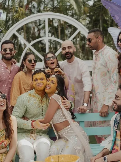 A beautiful group photo of the couple with their friends and family during the Haldi ceremony. A memory of love and togetherness.