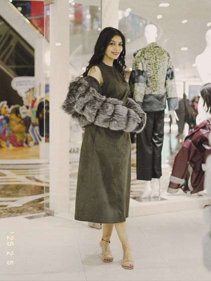 This grey fur jacket can be worn over the shoulders for a touch of old-school glamour. It's a versatile piece for your winter wardrobe.