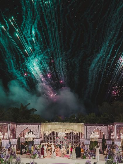 A spectacular fireworks display over the wedding mandap, creating a truly cinematic and unforgettable moment for the couple and their guests.