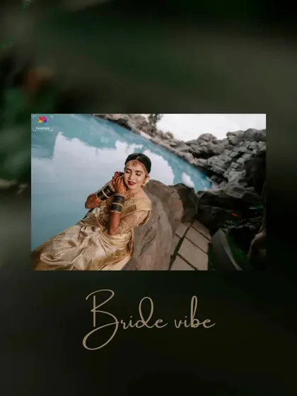 A serene bridal portrait taken by a poolside. The bride's golden saree and the calm water create a peaceful and beautiful "bride vibe."