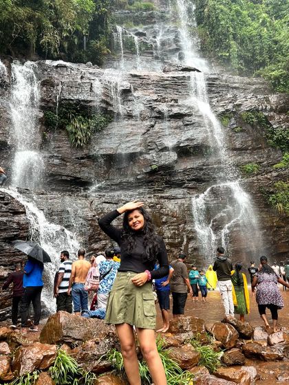 A traveler enjoying the magnificent Jhari Falls in Chikmagalur, one of the many beautiful spots on our leisure trips.