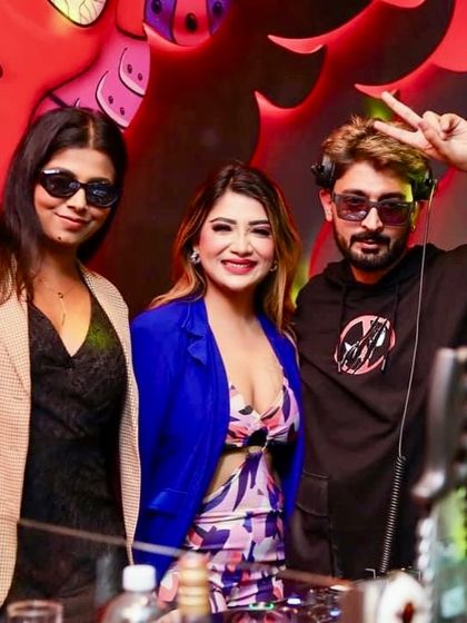 The whole group together for a photo at the DJ booth.