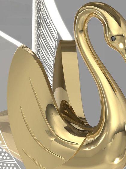 A close-up of the beautiful rose gold swan pendant. The craftsmanship and detail are exquisite.