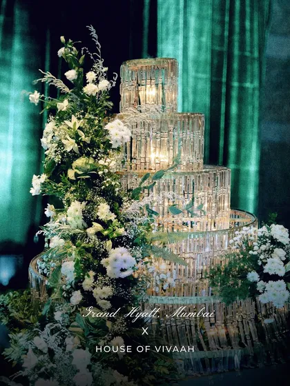 A close-up of the magnificent crystal installation, adorned with white florals and illuminated from within, standing as a testament to our love for statement decor pieces.