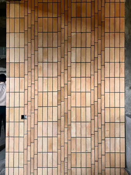 A work-in-progress detail of a brick facade. We explored various pixelated patterns to create a textured, visually engaging surface, showcasing our hands-on approach to material experimentation and craftsmanship on site.