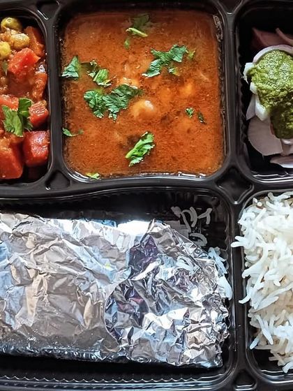 A bright and healthy thali with gajar matar (carrot and peas) sabzi and yellow chana. A delicious way to get your daily dose of vegetables.