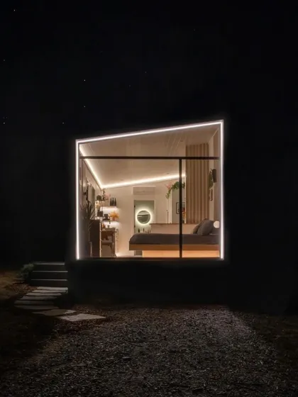 A night view of a modular holiday home, with its interior glowing like a lantern. This kind of aesthetic appeal translates directly to higher booking rates and better returns.