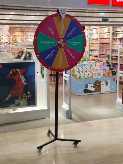 Another view of the spin the wheel game at a mall activation. It's portable, customizable, and comes with a sturdy stand.