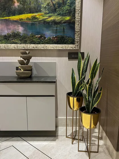 We also provide decor accents like these elegant golden metal planters. Paired with artificial snake plants, they add a touch of glamour and sophistication to this modern space.