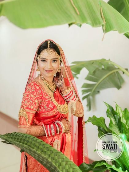 A lovely outdoor shot of our bride Kshitija. The natural greenery provides a beautiful backdrop for her red bridal attire.