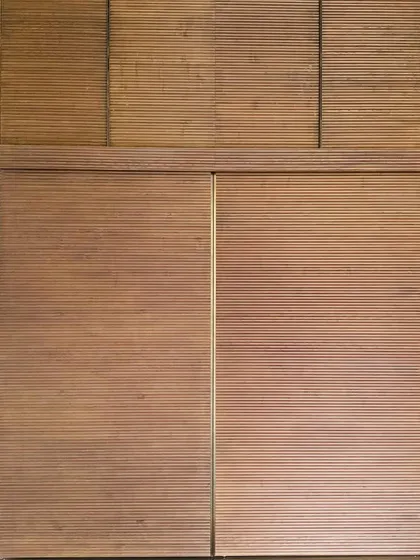 Fluted wooden panels for a wardrobe or wall cladding. The texture of the wood and the rhythm of the lines create a surface that is visually interesting and pleasing to the touch.