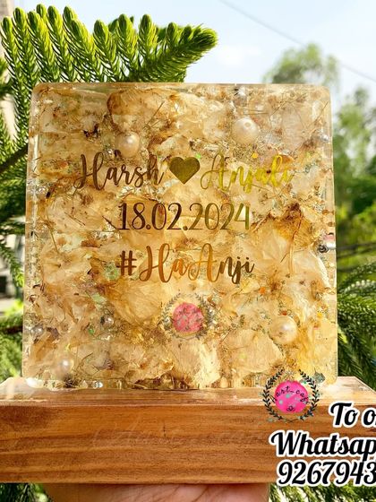 The same square lamp shown in natural daylight, highlighting the texture and sparkle of the preserved flowers. It's a beautiful decor piece, whether it's on or off.