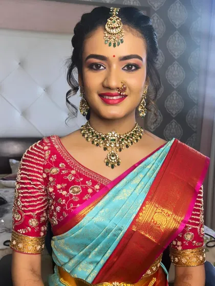 A classic South Indian traditional makeup look for a family wedding. I paired a warm, shimmering eye with a complementary pink lip shade to perfectly match her beautiful silk saree and temple jewelry.