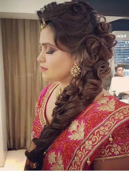 A great makeup look deserves an equally beautiful hairstyle. Here, you can see a soft glam makeup look paired with an intricate and voluminous braided hairstyle, creating a complete and elegant look for a wedding function.