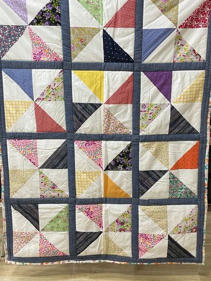 A classic half-square triangle quilt, using a variety of colorful scraps for a playful and timeless look.