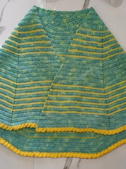 A similar semi-circle shawl in a fresh lime green and yellow color scheme. This one features a 'lemon frosting' edging for a fun, textured finish.