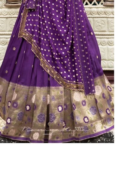 A close-up of the traditional Paithani border on the lehenga skirt, showcasing the intricate weaving and floral motifs.