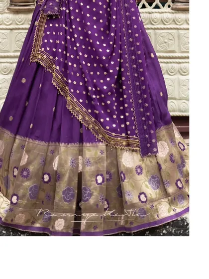 A detail shot of the Paithani lehenga skirt, revealing the beautiful woven floral border that is characteristic of this traditional textile art.