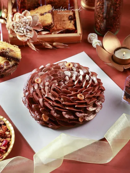 This chocolate hazelnut cake is a work of art. I used dramatic lighting to highlight the intricate, petal-like chocolate frosting, making it look like a sculpture.