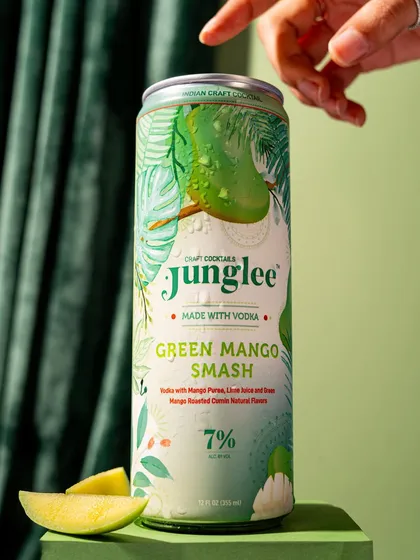 A clean, product-focused shot of a Junglee can. The simple background and minimal props put the focus squarely on the beautiful can design and branding.