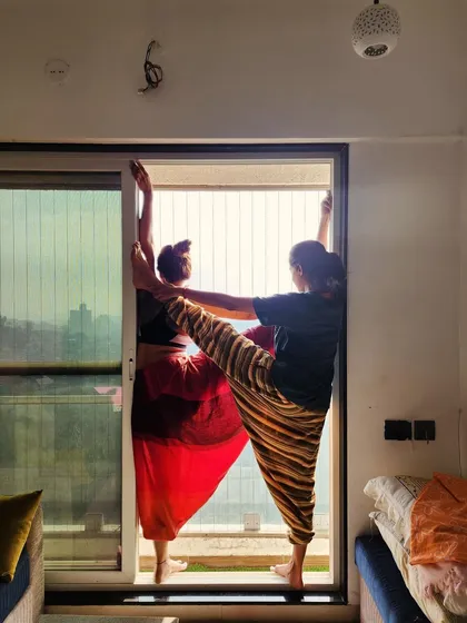 Practicing with a partner can bring a new dimension to your asana. Here, we explore a supported standing split, building trust and shared focus.